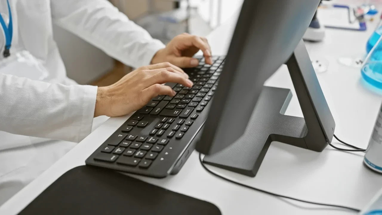 Arzt tippt auf Tastatur